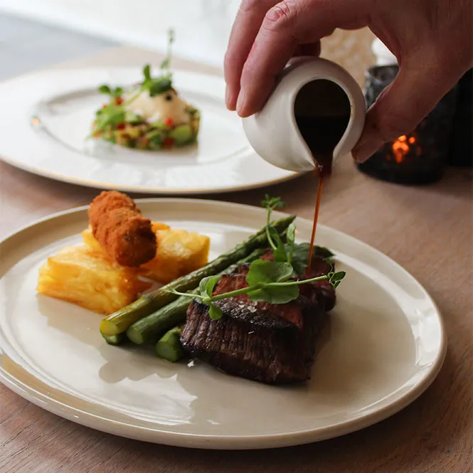 Chef of Restaurant Sophia serving a dish