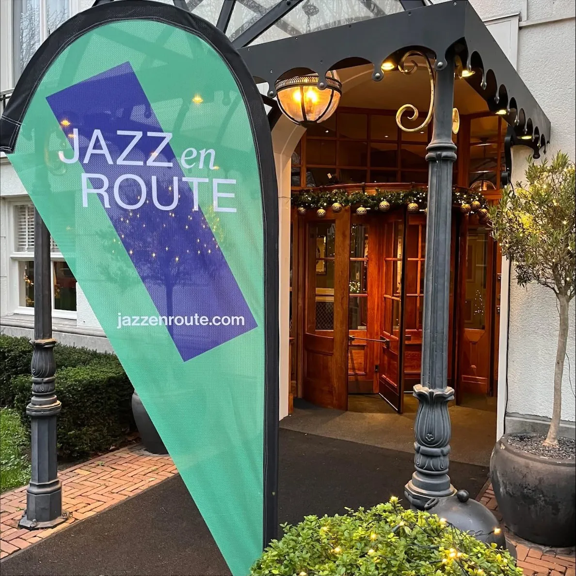 Entrance of the Carlton Ambassador Hotel with a Jazz en Route flag