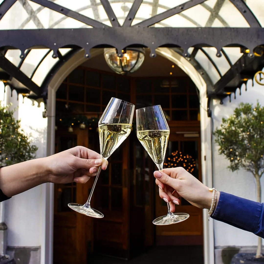 Clinking Champagne Glasses at the Entrance of the Carlton Ambassador
